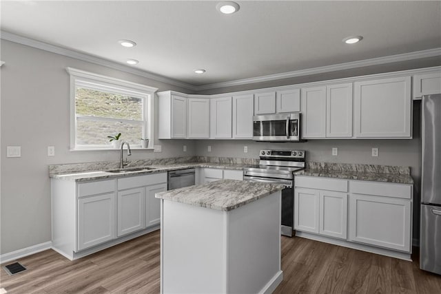 260 Lily Ridge Dr, North Strabane, PA 15317 - kitchen featuring stainless steel appliances, wood finished floors, ornamental molding, white cabinets, and recessed lighting