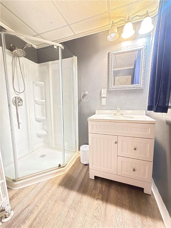 832 Maplewood Ave, Ambridge, PA 15003 - bathroom featuring a shower stall, wood finished floors, vanity, and a drop ceiling