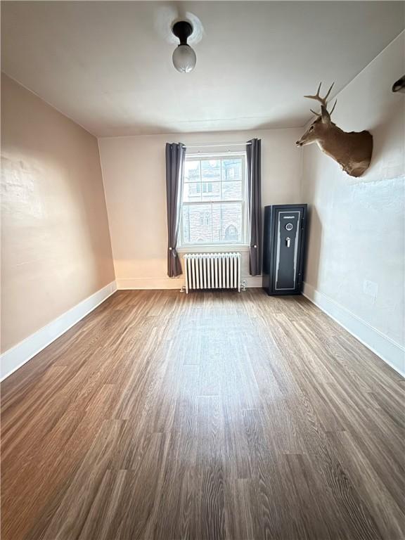 832 Maplewood Ave, Ambridge, PA 15003 - unfurnished living room with radiator and wood finished floors