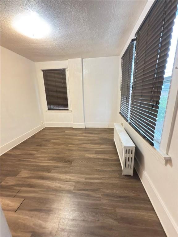 832 Maplewood Ave, Ambridge, PA 15003 - spare room featuring radiator heating unit, a textured ceiling, and wood finished floors