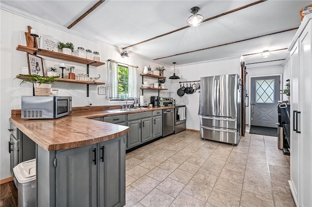 8995 Puritan Ln, Conneaut Twp, PA 16424 - kitchen with appliances with stainless steel finishes, gray cabinetry, open shelves, a peninsula, and crown molding