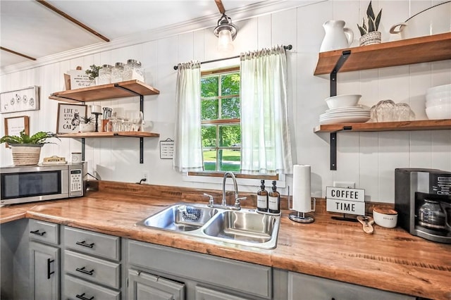 8995 Puritan Ln, Conneaut Twp, PA 16424 - kitchen featuring open shelves, stainless steel microwave, gray cabinets, crown molding, and light countertops