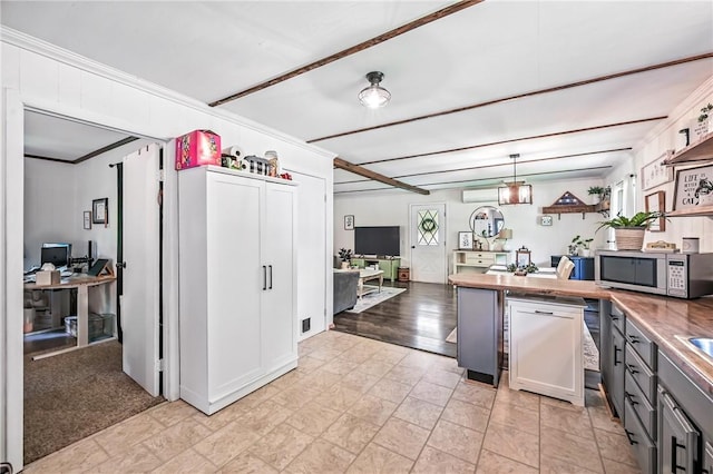 8995 Puritan Ln, Conneaut Twp, PA 16424 - kitchen with stainless steel microwave, a desk, crown molding, gray cabinetry, and hanging light fixtures