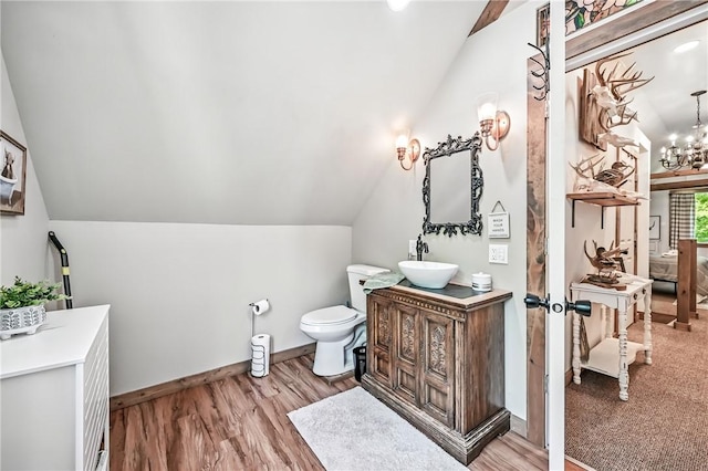 8995 Puritan Ln, Conneaut Twp, PA 16424 - bathroom featuring vaulted ceiling, wood finished floors, vanity, and a chandelier