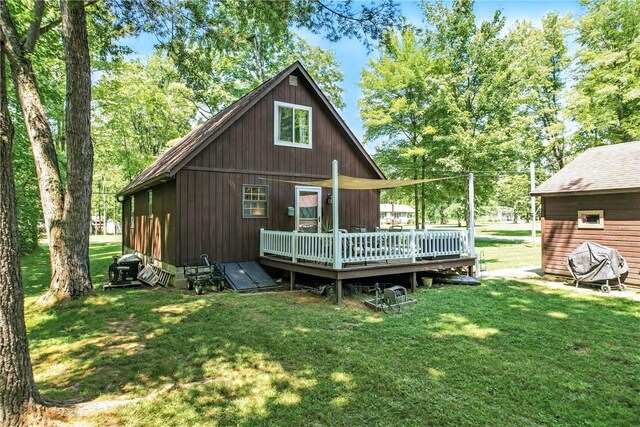 8995 Puritan Ln, Conneaut Twp, PA 16424 - rear view of house featuring a deck and a yard