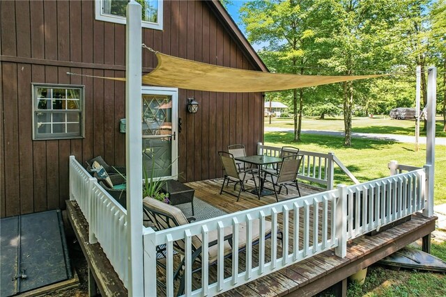8995 Puritan Ln, Conneaut Twp, PA 16424 - wooden deck featuring outdoor dining space and a yard