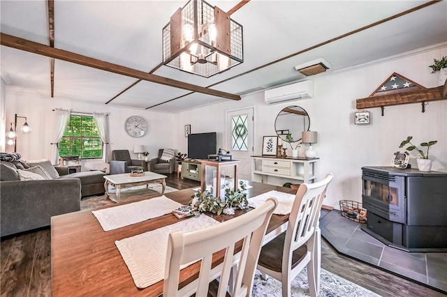 8995 Puritan Ln, Conneaut Twp, PA 16424 - dining area featuring a wall mounted air conditioner, a wood stove, wood finished floors, a chandelier, and beam ceiling