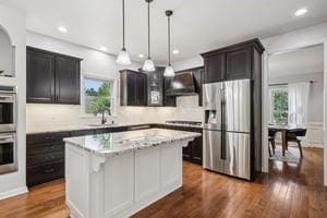 403 Worth Ct, Cranberry Twp, PA 16066 - kitchen with stainless steel appliances, ventilation hood, tasteful backsplash, dark wood-style flooring, and hanging light fixtures