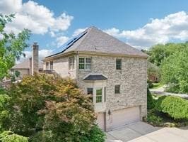 403 Worth Ct, Cranberry Twp, PA 16066 - view of home's exterior with driveway, a garage, stone siding, and roof mounted solar panels