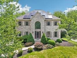 403 Worth Ct, Cranberry Twp, PA 16066 - french country home featuring solar panels, a front yard, and stone siding