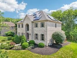 403 Worth Ct, Cranberry Twp, PA 16066 - french country style house featuring a front yard, roof mounted solar panels, and stone siding