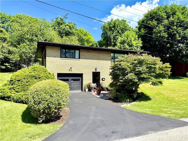 110 Surrey St, Monessen, PA 15062 - view of front of property featuring brick siding, an attached garage, asphalt driveway, and a front lawn