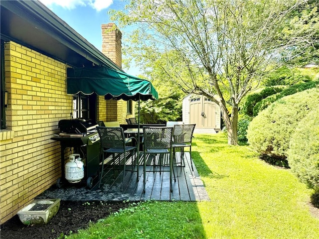 110 Surrey St, Monessen, PA 15062 - deck with a storage shed, outdoor dining space, a yard, and a grill