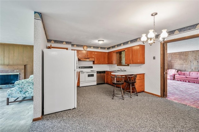 4852 Thomason Rd, South Pymatuning Twp, PA 16150 - kitchen featuring white appliances, a chandelier, light colored carpet, light countertops, and brown cabinetry