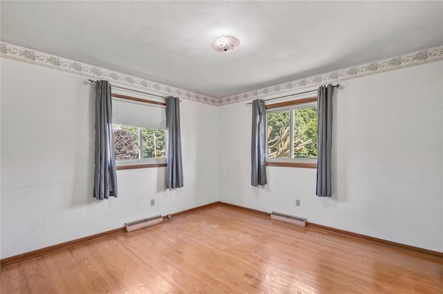 4852 Thomason Rd, South Pymatuning Twp, PA 16150 - empty room featuring a baseboard heating unit and wood finished floors
