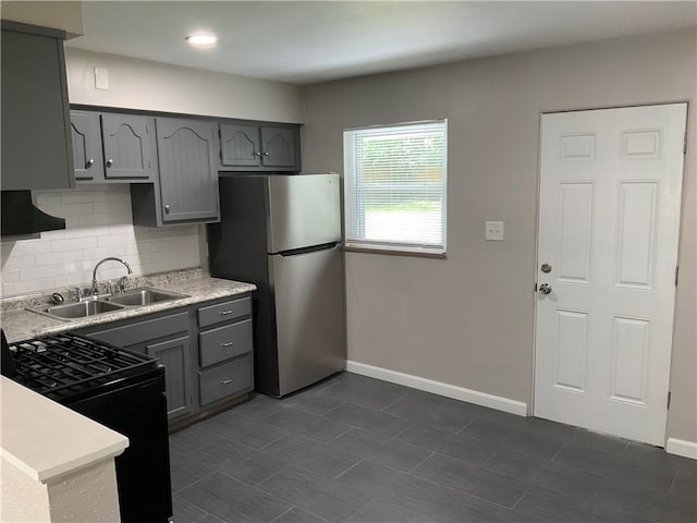 634 Idaho Ave, Verona, PA 15147 - kitchen featuring freestanding refrigerator, gray cabinetry, black gas stove, tasteful backsplash, and light countertops
