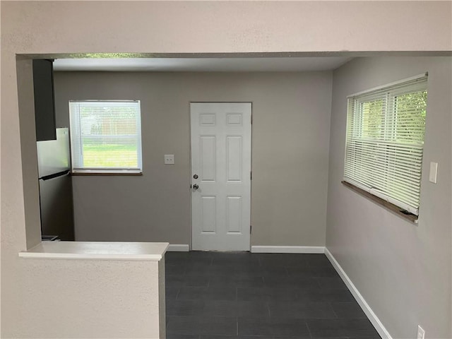 634 Idaho Ave, Verona, PA 15147 - entrance foyer with healthy amount of natural light and dark tile patterned flooring