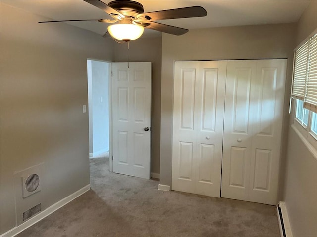 634 Idaho Ave, Verona, PA 15147 - unfurnished bedroom featuring baseboard heating, carpet flooring, a closet, a baseboard heating unit, and ceiling fan
