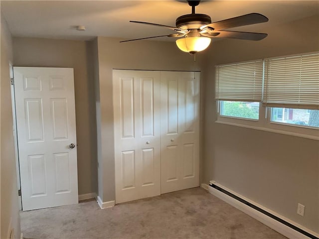 634 Idaho Ave, Verona, PA 15147 - unfurnished bedroom with a baseboard radiator, light carpet, a closet, and a ceiling fan