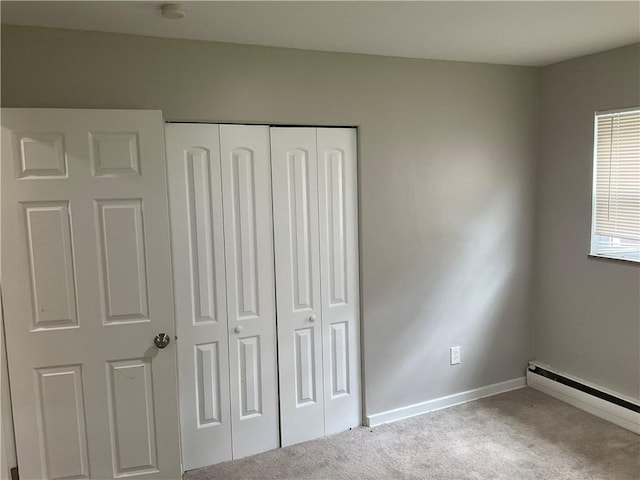 634 Idaho Ave, Verona, PA 15147 - unfurnished bedroom with a baseboard radiator, carpet floors, and a closet