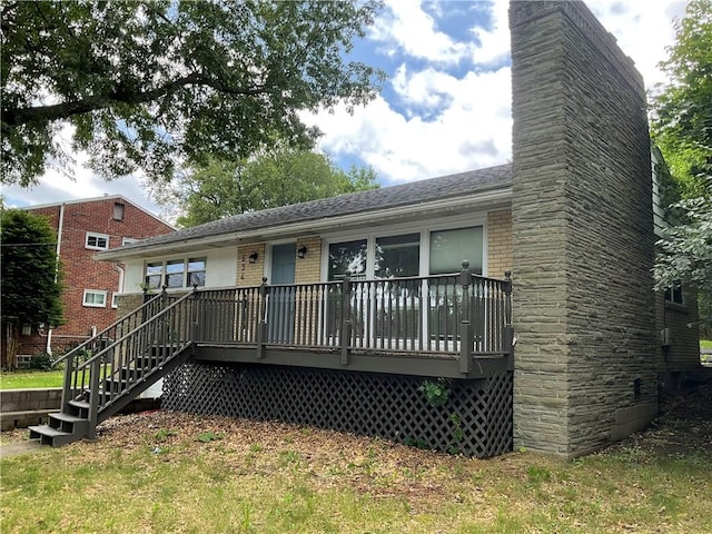 634 Idaho Ave, Verona, PA 15147 - rear view of property with a chimney, roof with shingles, a wooden deck, brick siding, and stairway