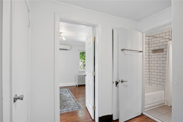 3863 Beechwood Blvd, Greenfield, PA 15217 - bathroom with radiator, an AC wall unit, ornamental molding, wood finished floors, and shower / bath combo with shower curtain
