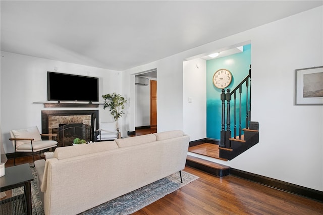 3863 Beechwood Blvd, Greenfield, PA 15217 - living area with a wall mounted AC, stairway, a stone fireplace, and wood finished floors