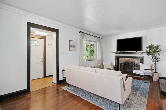 3863 Beechwood Blvd, Greenfield, PA 15217 - living area with radiator, a stone fireplace, and wood finished floors