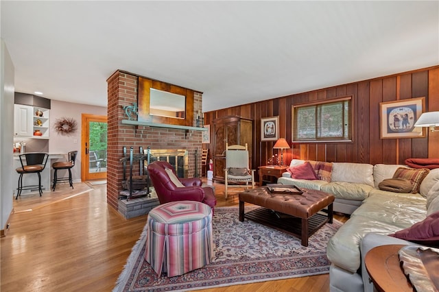 2666 Pointview Dr, Hampton, PA 15101 - living room with healthy amount of natural light, a fireplace, wooden walls, and wood finished floors