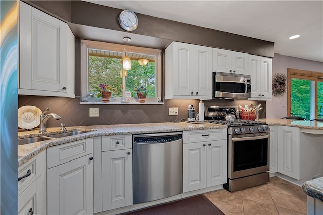 2666 Pointview Dr, Hampton, PA 15101 - kitchen featuring appliances with stainless steel finishes, white cabinets, decorative backsplash, light stone countertops, and recessed lighting