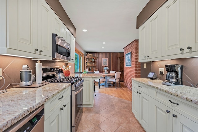 2666 Pointview Dr, Hampton, PA 15101 - kitchen featuring appliances with stainless steel finishes, tasteful backsplash, recessed lighting, light stone countertops, and white cabinetry