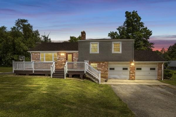 408 Circle Dr, Franklin Twp, PA 16117 - split level home with driveway, brick siding, a front lawn, a wooden deck, and a chimney