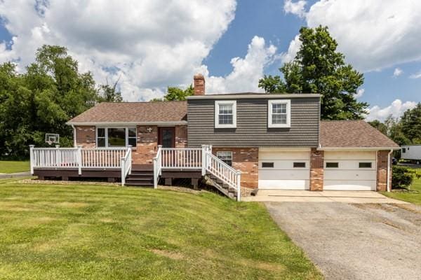 408 Circle Dr, Franklin Twp, PA 16117 - tri-level home with asphalt driveway, a front yard, a chimney, and brick siding