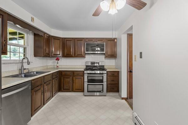 408 Circle Dr, Franklin Twp, PA 16117 - kitchen featuring appliances with stainless steel finishes, light countertops, ceiling fan, and light floors