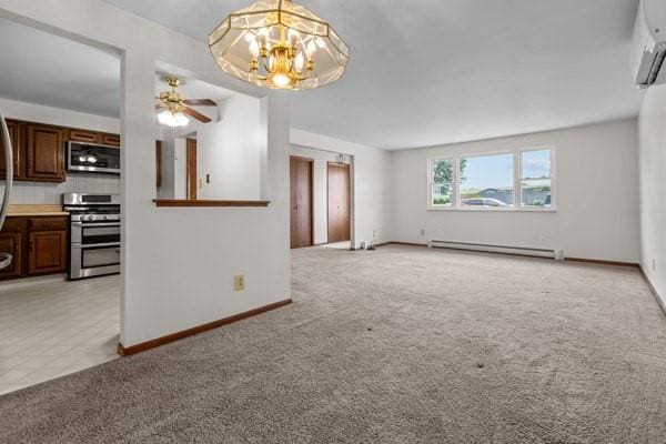 408 Circle Dr, Franklin Twp, PA 16117 - unfurnished living room with baseboard heating, light carpet, a wall mounted air conditioner, and a chandelier