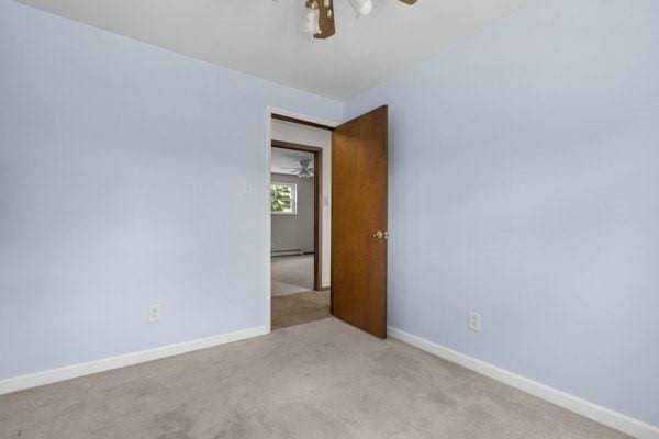 408 Circle Dr, Franklin Twp, PA 16117 - carpeted spare room featuring ceiling fan and baseboard heating
