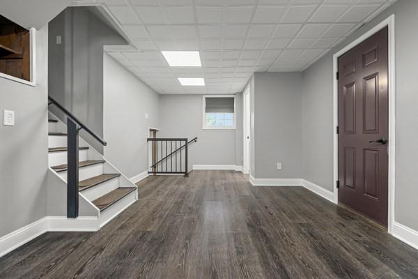 408 Circle Dr, Franklin Twp, PA 16117 - below grade area featuring wood finished floors and stairs