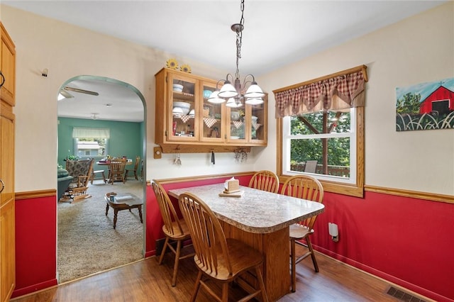 817 E Jamestown Rd, Green Twp, PA 16134 - dining space featuring wood finished floors, arched walkways, and a chandelier