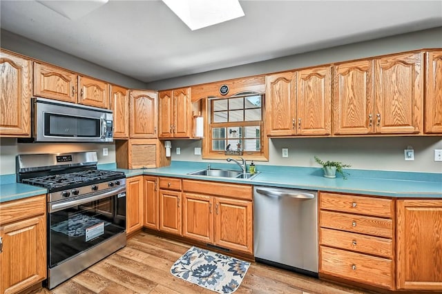 2801 Valley View Rd, South Pymatuning Twp, PA 16150 - kitchen featuring stainless steel appliances, light wood-style flooring, a skylight, and light countertops