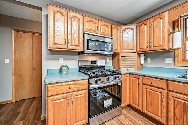 2801 Valley View Rd, South Pymatuning Twp, PA 16150 - kitchen featuring appliances with stainless steel finishes, light wood finished floors, and light countertops