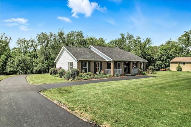 2801 Valley View Rd, South Pymatuning Twp, PA 16150 - ranch-style home featuring a porch, a front lawn, brick siding, and roof with shingles