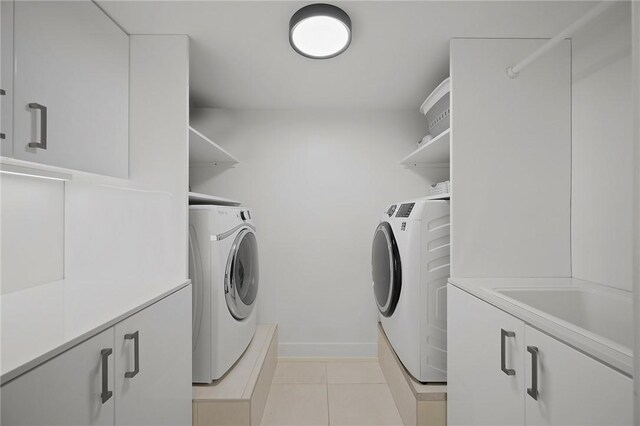 316 Beaver St Unit 301, Sewickley, PA 15143 - washroom featuring washing machine and dryer, light tile patterned floors, and cabinet space