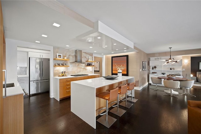 316 Beaver St Unit 301, Sewickley, PA 15143 - kitchen featuring high quality fridge, modern cabinets, wall chimney range hood, light countertops, and dark wood-type flooring