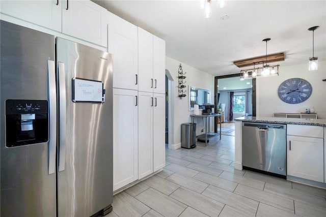 115 Muddy Creek Dr, Center Twp, PA 16001 - kitchen with appliances with stainless steel finishes, white cabinets, hanging light fixtures, and dark stone countertops