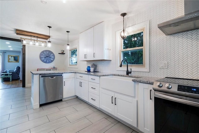 115 Muddy Creek Dr, Center Twp, PA 16001 - kitchen featuring appliances with stainless steel finishes, wall chimney range hood, white cabinetry, and light stone counters
