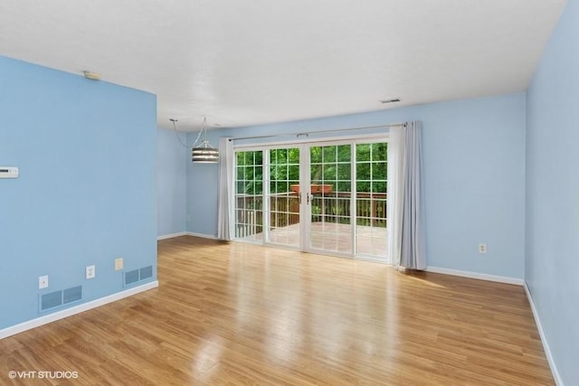 82 Monmouth Dr, Cranberry Twp, PA 16066 - empty room featuring wood finished floors, a chandelier, and french doors