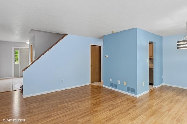 82 Monmouth Dr, Cranberry Twp, PA 16066 - unfurnished living room with light wood-style floors and stairway