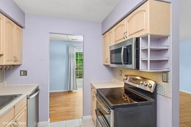82 Monmouth Dr, Cranberry Twp, PA 16066 - kitchen featuring appliances with stainless steel finishes, light brown cabinets, tasteful backsplash, light countertops, and light tile patterned floors