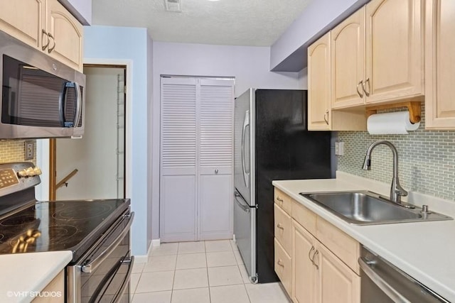 82 Monmouth Dr, Cranberry Twp, PA 16066 - kitchen with stainless steel appliances, light brown cabinets, backsplash, light tile patterned floors, and a textured ceiling