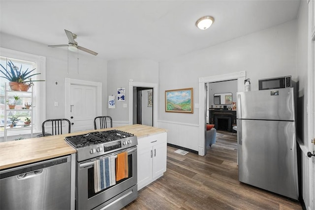 11 Walnut St, Crafton, PA 15205 - kitchen featuring stainless steel appliances, butcher block countertops, ceiling fan, white cabinets, and dark wood-style flooring